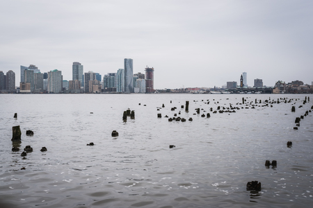 View of Manhattan skyline from Hudson River Greenway in New York by a blue sky overcastのeditorial素材