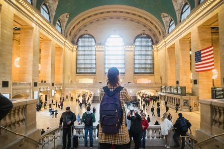 NEW YORK,USA - FEBRUARY 24, 2018: Tourist taking a photo of Grand Central Station in New York among...