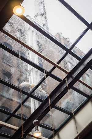 Rainy day under the glass roof of a building in New York Cityの写真素材