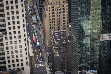Aerial view of traffic on New York streets at the end of the day from a skyscraper through buildingsの写真素材
