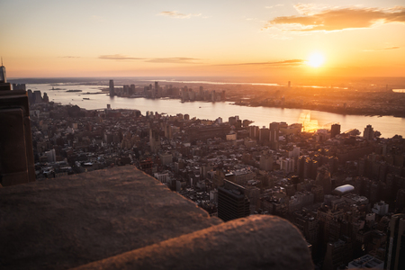 Aerial view of sun shining at sunset over Manhattan and Jersey in New Yorkの写真素材