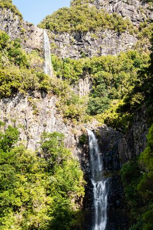 View of a huge waterfall in the middle of a levada in Madeiraの写真素材