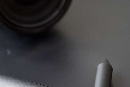 Graphics tablet with stylus and lens for photo post-processingの写真素材