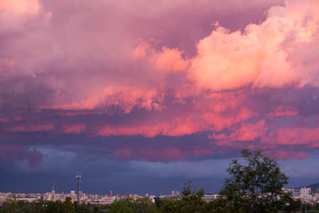 Dramatic and cloudy sky in a purple, blue and orange colors backgroundの写真素材