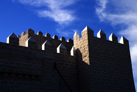 High contrast medieval castle spires against a deep blue sky