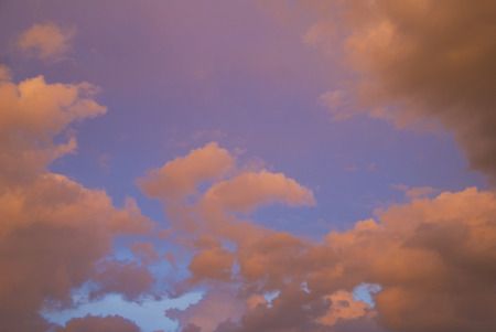 Very colorful clouds at sunset with a blue sky background