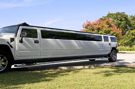 White stretch limousine with partly cloudy blue skyの写真素材