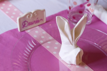 Pink and White holiday dinner placement set with rabbit ear folded napkinの写真素材