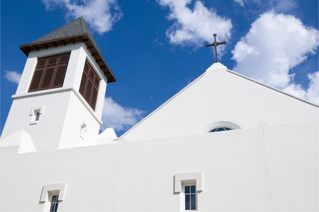 Modern christian church steeple with cross and blue skyの写真素材