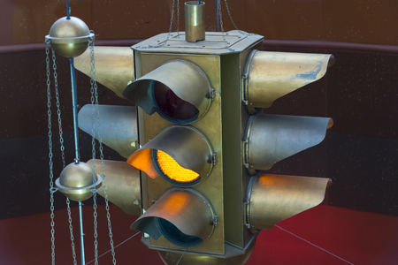 Brass traffic signal decoration light showing the caution yellow light lit