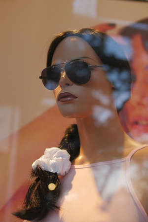 mannequin with sunglasses in window display