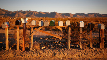 Several mailboxes in the desert during sunsetの写真素材