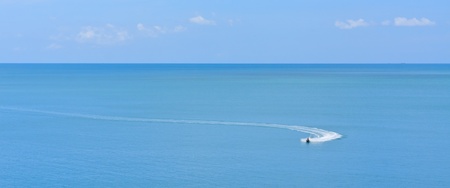 jetski racing on a blue water and blue sky as background の写真素材