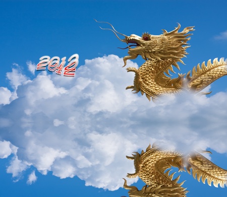 gold dragon fly over blue sky and big white cloud...2012 year of 	gold dragon fly over blue sky and big white cloud...2012 year of dragonの写真素材