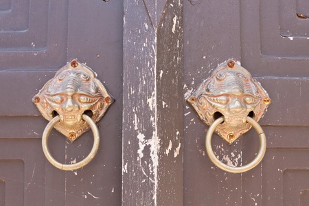 chinese door with a lion-sing-ha head in Thai temple の写真素材