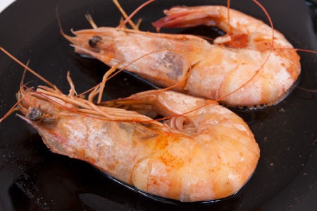 shrimp and sweet sauce on black plateの写真素材