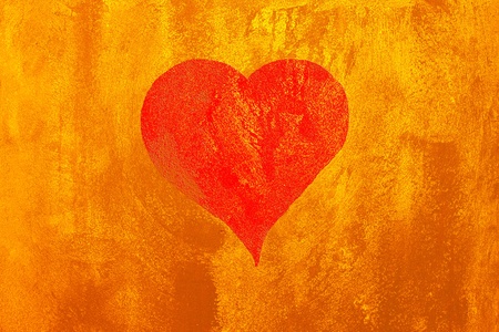 Red heart on abstract  yellow cement backgroundの写真素材