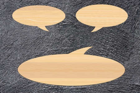 wooden speech bubble on cement background