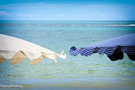 blue Beach umbrella on a sunny day, sea in backgroundの写真素材