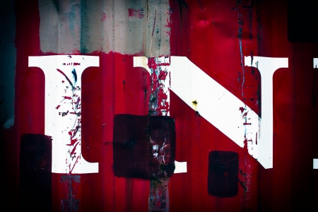 White paint splatters on a red steel wall background texture