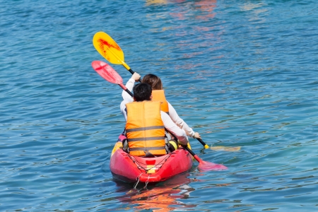 Tourist  kayaking in the Thai ocean from backward viewの写真素材