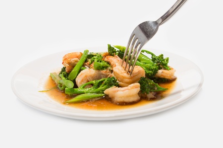 Prawns with broccoli fried sauce on white dishの写真素材
