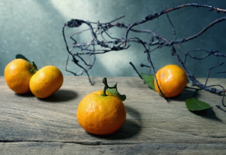 Still life with orange fruites on wooden table with grunge backgroundの写真素材