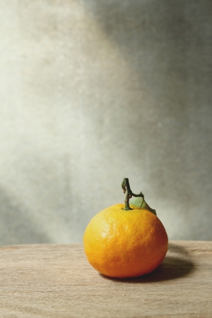 Still life with orange fruites on wooden table with grunge backgroundの写真素材