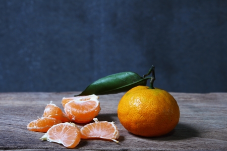 Still life with orange fruites on wooden table with grunge backgroundの写真素材