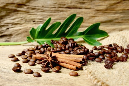 Roasted coffee beans  on sackcloth with grunge wooden  backgroundの写真素材