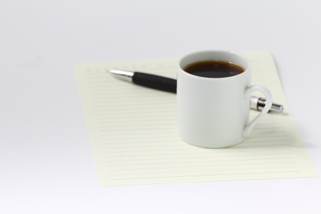 Blank  paper and  black coffee cup on white backgroundの写真素材
