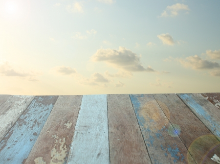 Grunge wooden floor with sunrise sky backgroundの写真素材