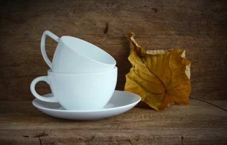 White coffee cup on wood board の写真素材