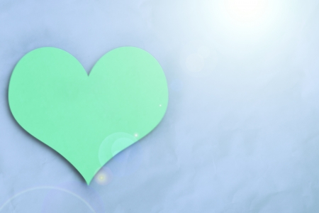 green heart on blue crumpled paper  backgroundの写真素材