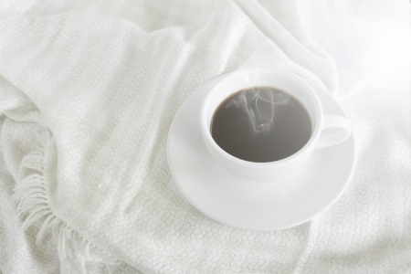 Hot coffee cup on silk tablecloth in vintage style の写真素材