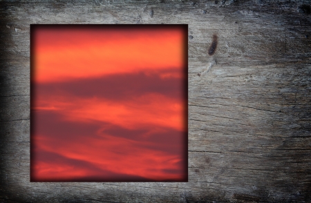 Old wood frame with red sunset sky  image backgroundの写真素材
