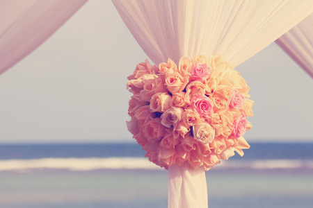 Vintage roses bouquet arrange for wedding decoration with sea backgroundの写真素材