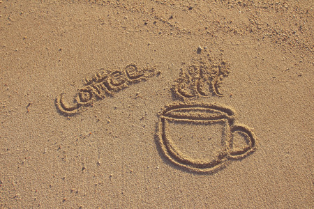 Vintage coffee cup  drawn on sand beach,filtered imageの写真素材