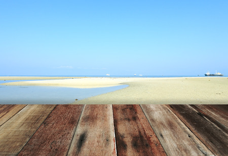 wood floor with blue sky white sand beach backgroundの写真素材