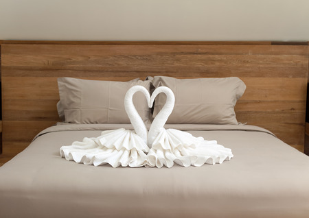 Bedroom interior design with swans from the towel decoration on  bed の写真素材