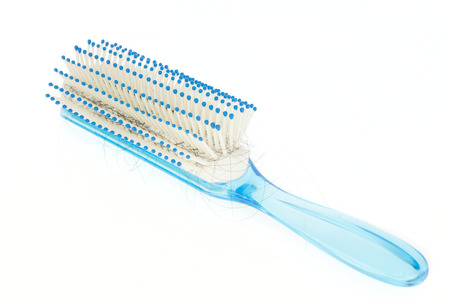 Hairbrush with lock of hair lost on white background の写真素材