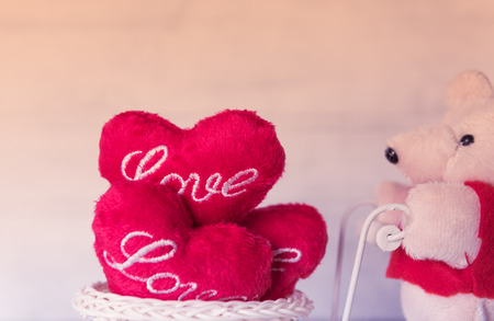 Teddy bear and red hearts with filter vintage effectの写真素材
