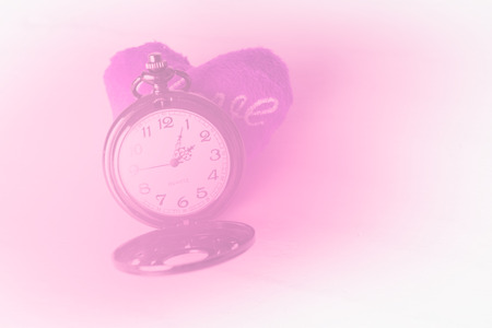 Classic pocket watch and purple heart on grunge wood backgroundの写真素材
