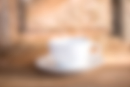 Abstract coffee cup on wood board with filter blur effectの写真素材