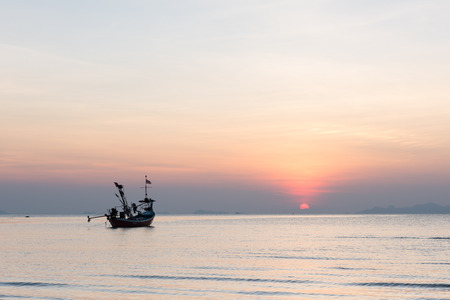 Seascape sunset with longtail boat floatingの写真素材