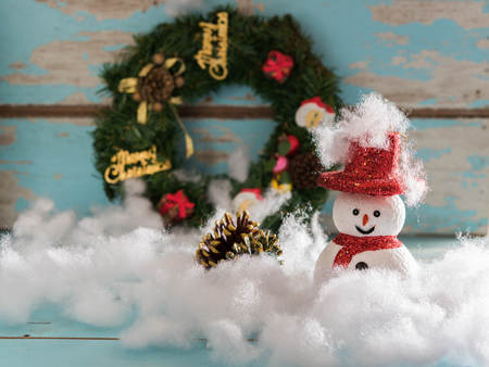 Christmas snowman and gifts decorated on grunge blue wooden backgroundの写真素材