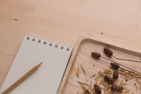 Top view work space notebook and brown pencil on wood table backgroundの写真素材