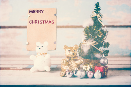 Cute teddy bears and  christmas decorations with brown paper for text on grunge blue wooden backgroundの写真素材