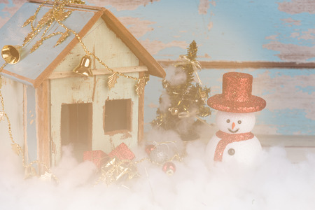 Christmas snowman,Santa and gifts decorated on grunge blue wooden backgroundの写真素材