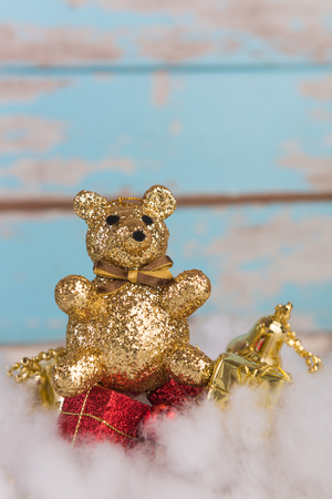 Christmas cute teddy bear and red gift box on blue wood backgroundの写真素材